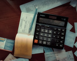 a calculator sitting on top of a wooden table