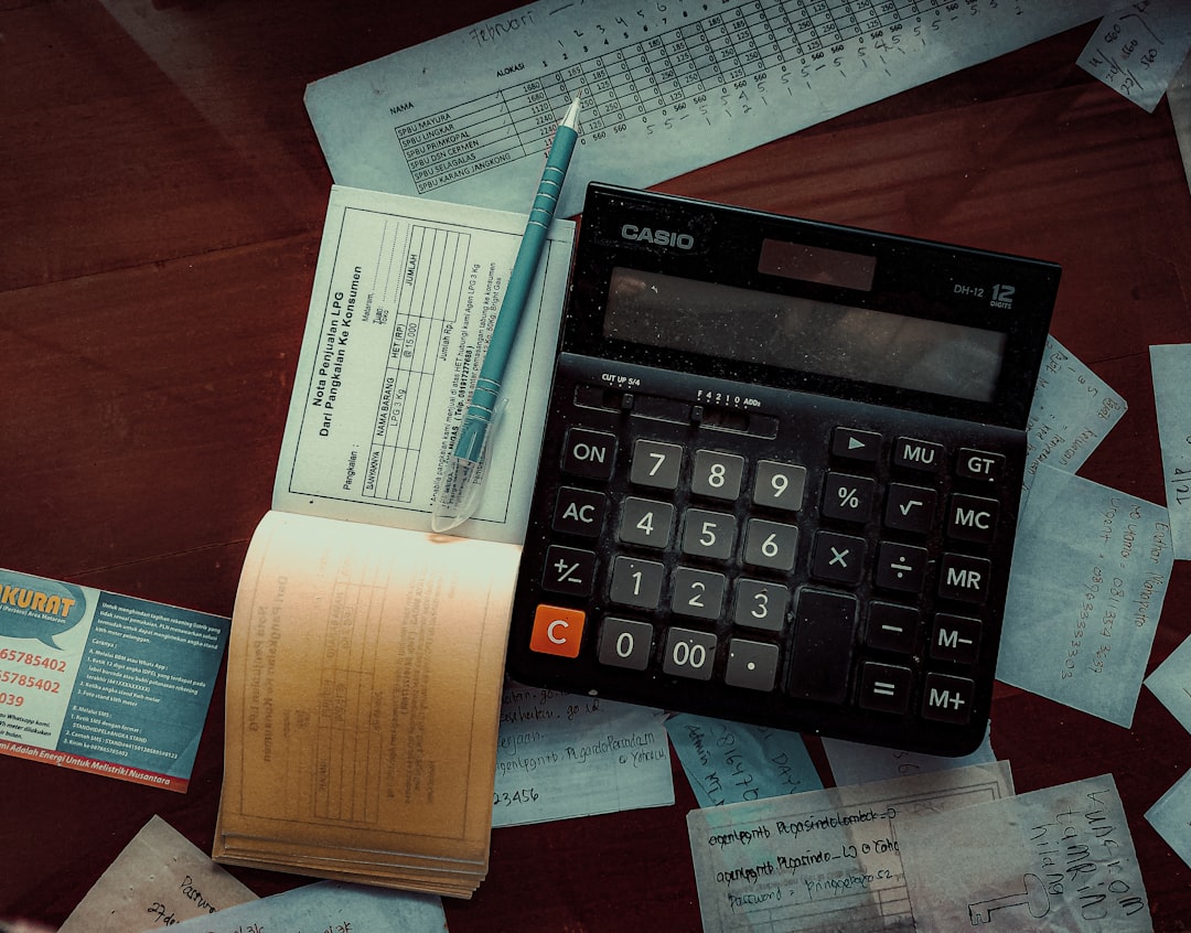 a calculator sitting on top of a wooden table, Workday