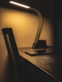 A cozy workspace featuring the robot and a glowing desk lamp.