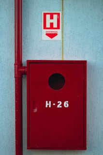 a red mailbox on the side of a building