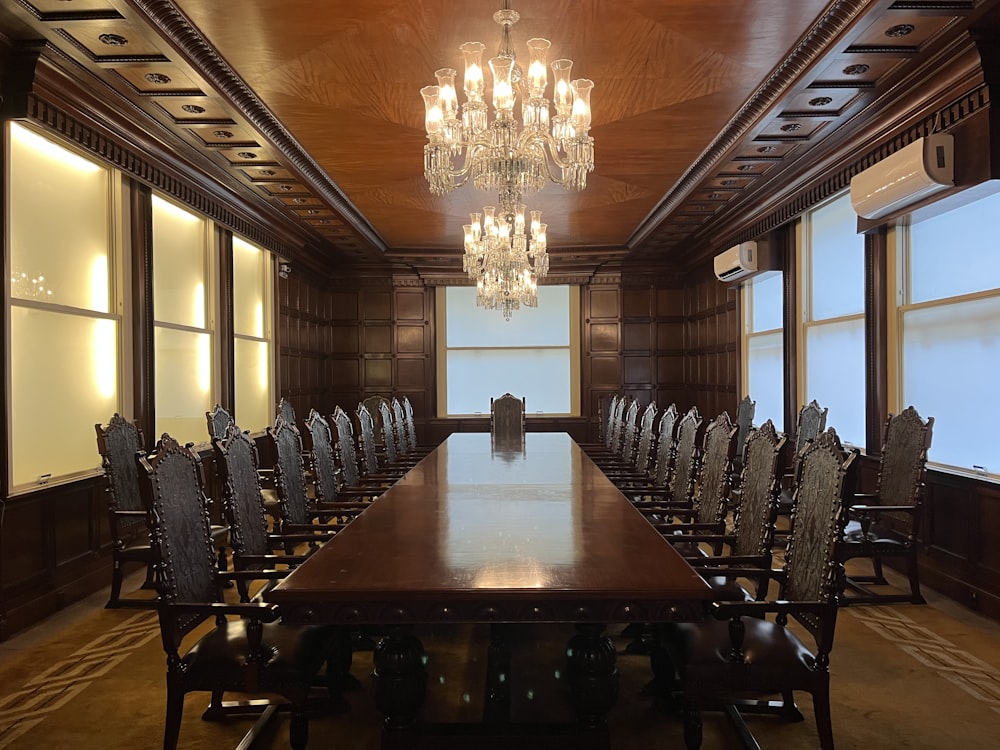 a large conference room with a chandelier hanging from the ceiling