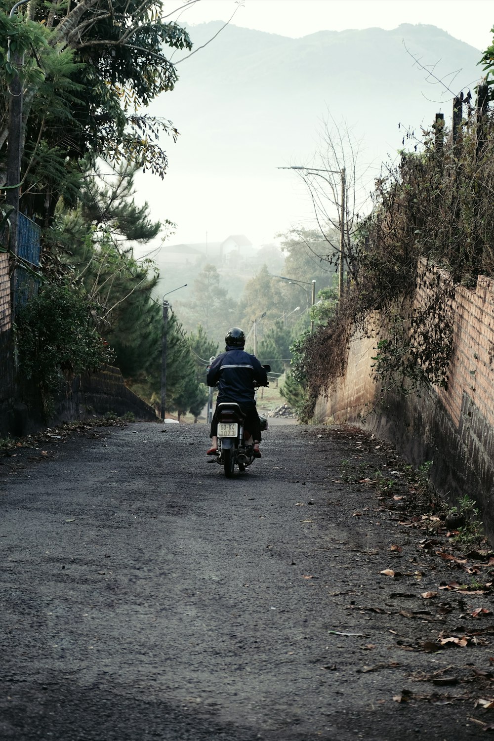 a person riding a motorcycle down a road