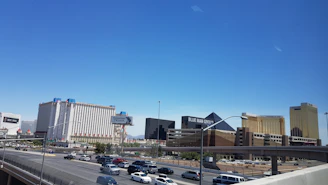 A real estate investor reviewing property listings on a tablet with Las Vegas landmarks visible.