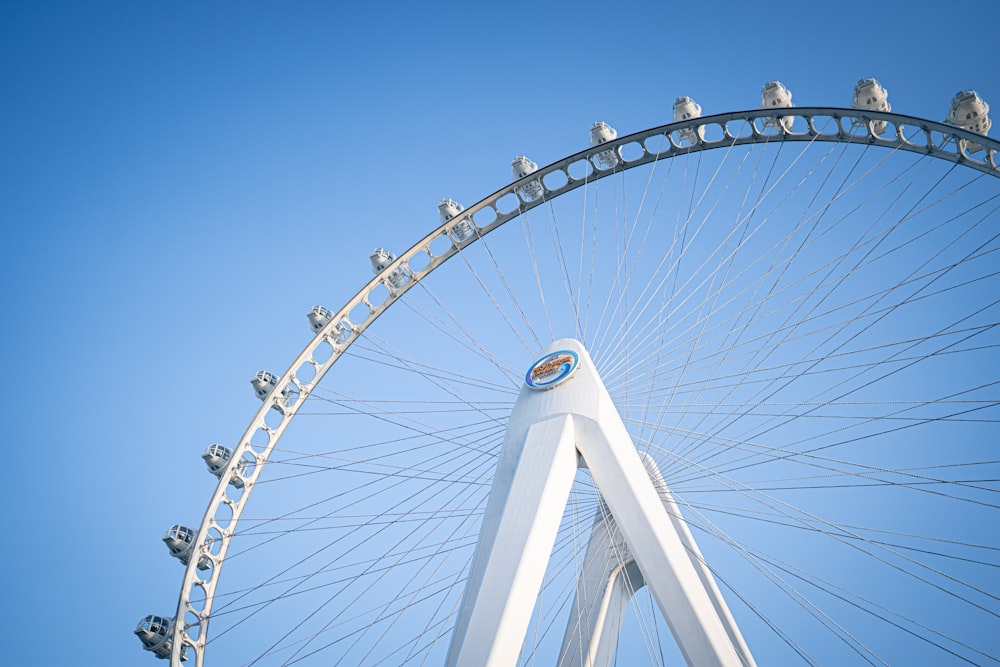 a large white ferris wheel against a blue sky