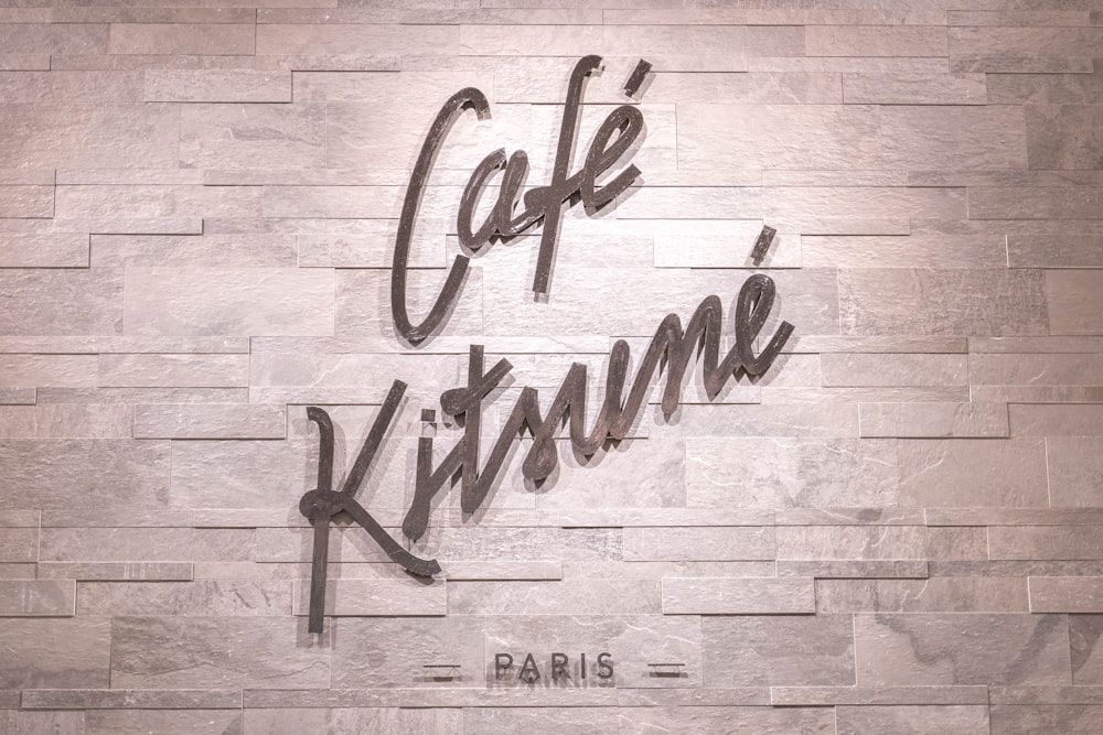 a sign that reads cafe krime paris on a wall