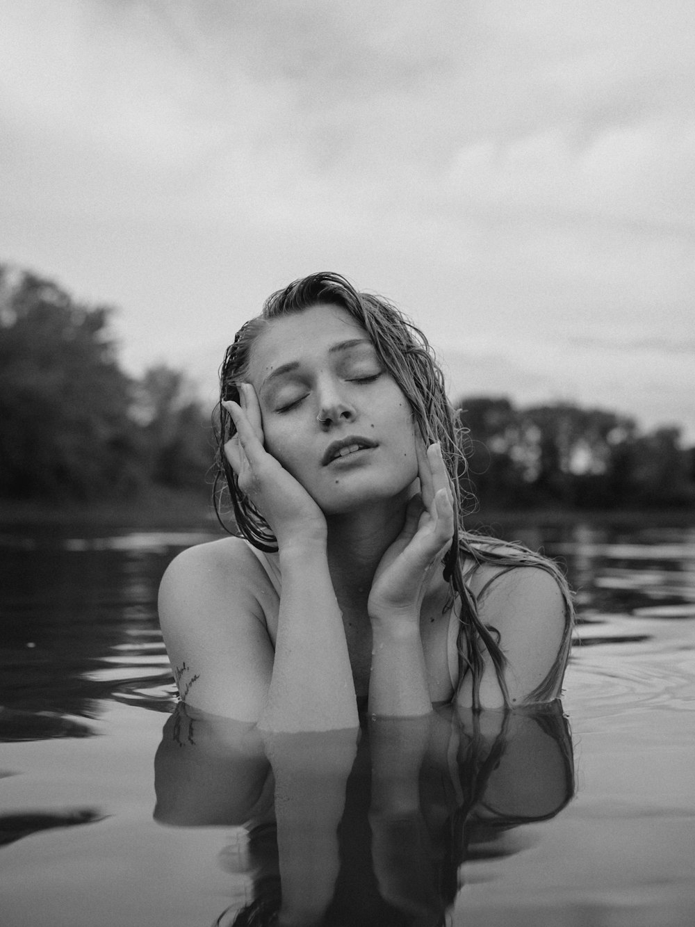 a woman in the water with her eyes closed