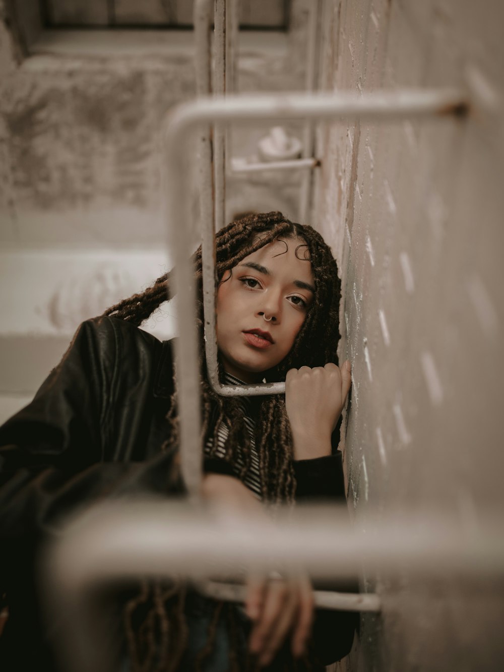 a woman with dreadlocks standing in front of a mirror