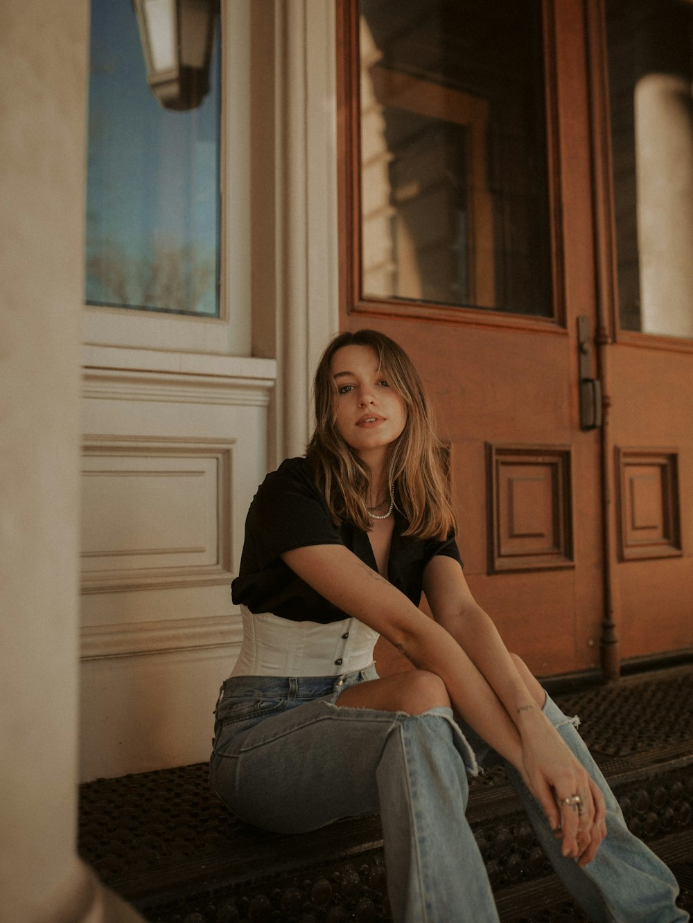 a woman sitting on the steps of a building