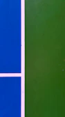 Close-up of a freshly painted college basketball court with team logos visible.