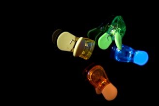 Close-up of the adaptive bikini's side clip mechanism in neon green against white fabric.