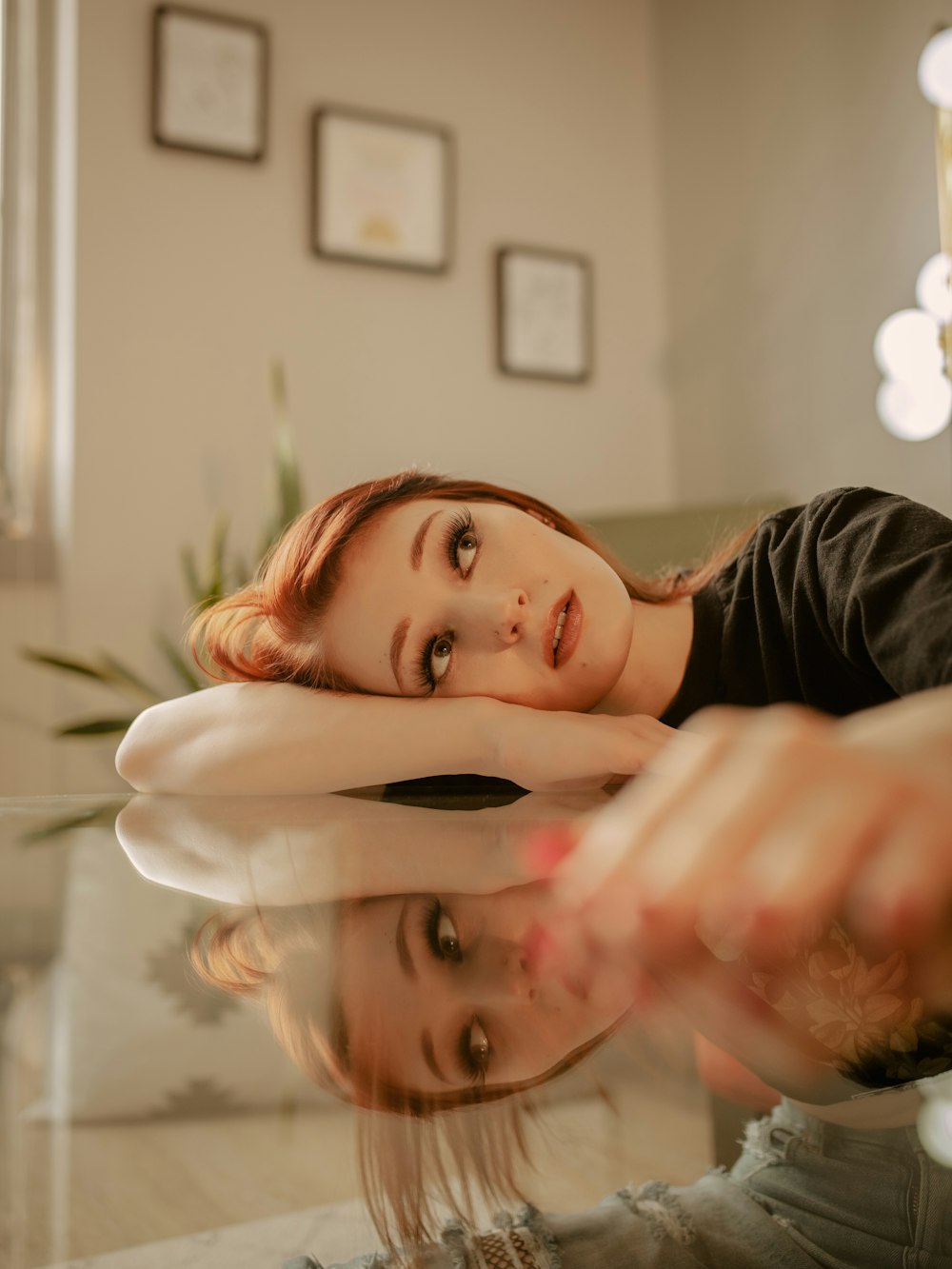 a woman sitting on a couch with her hand on her face