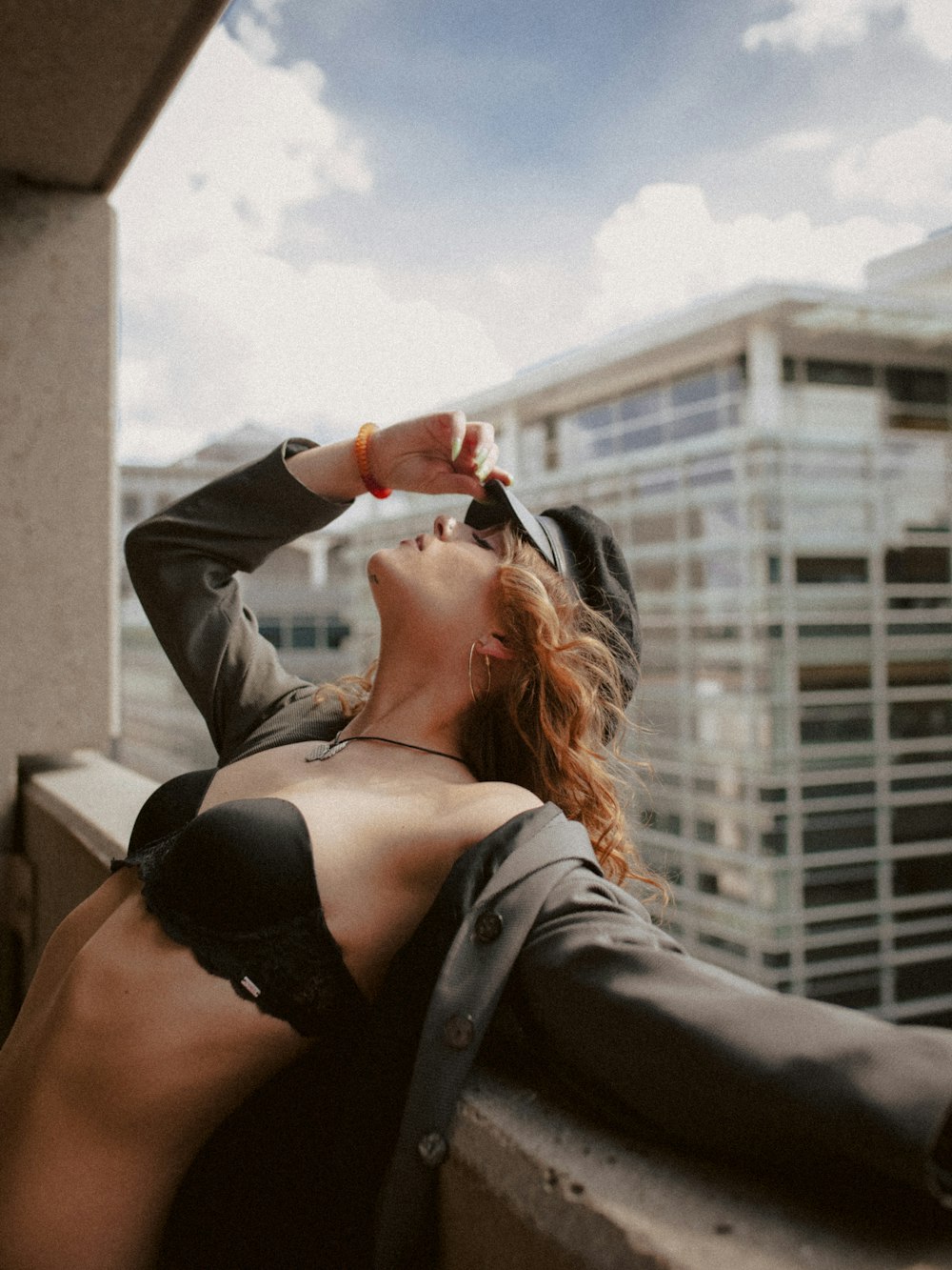 a woman in a bra top is leaning on a ledge