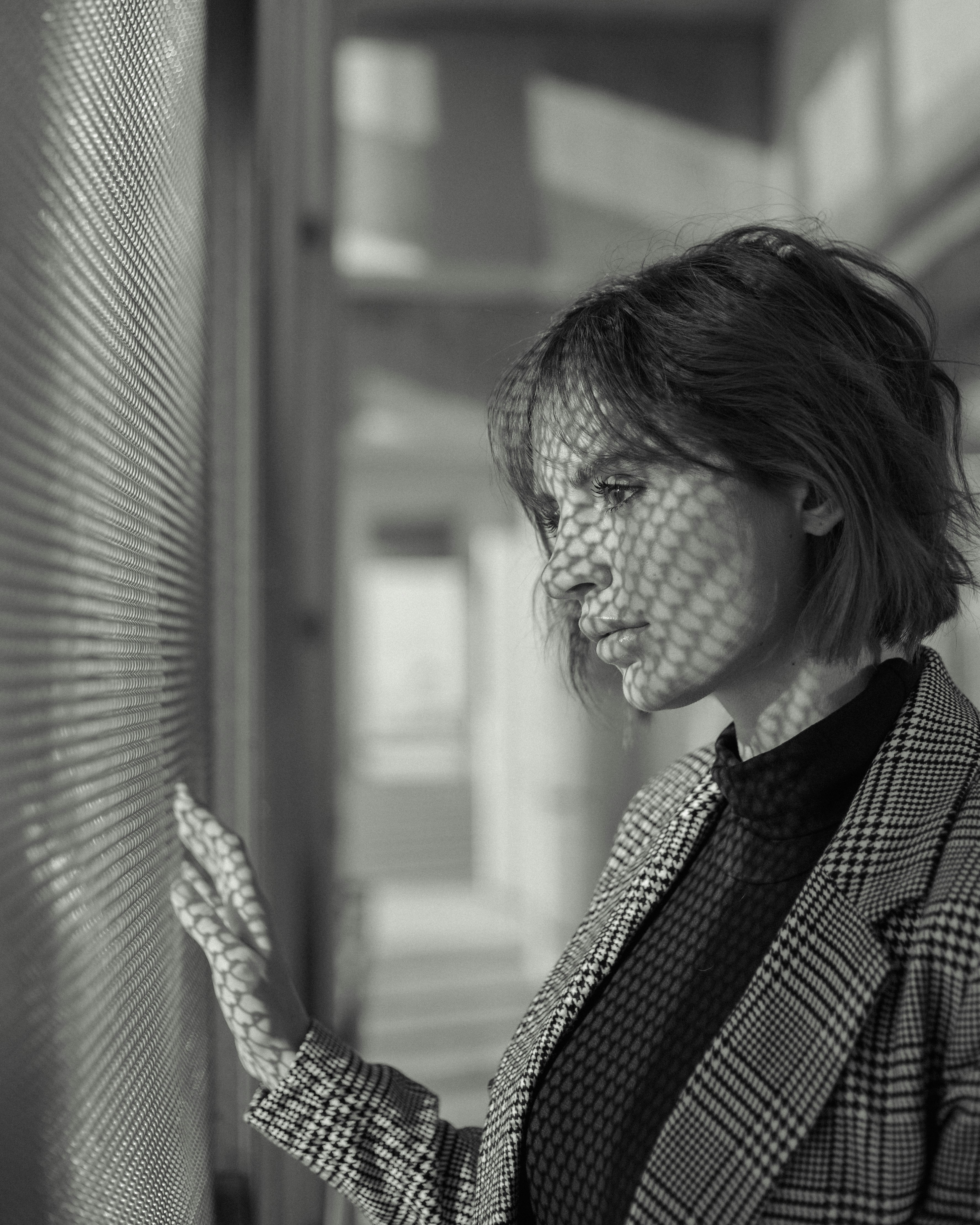 a woman standing next to a window in a building