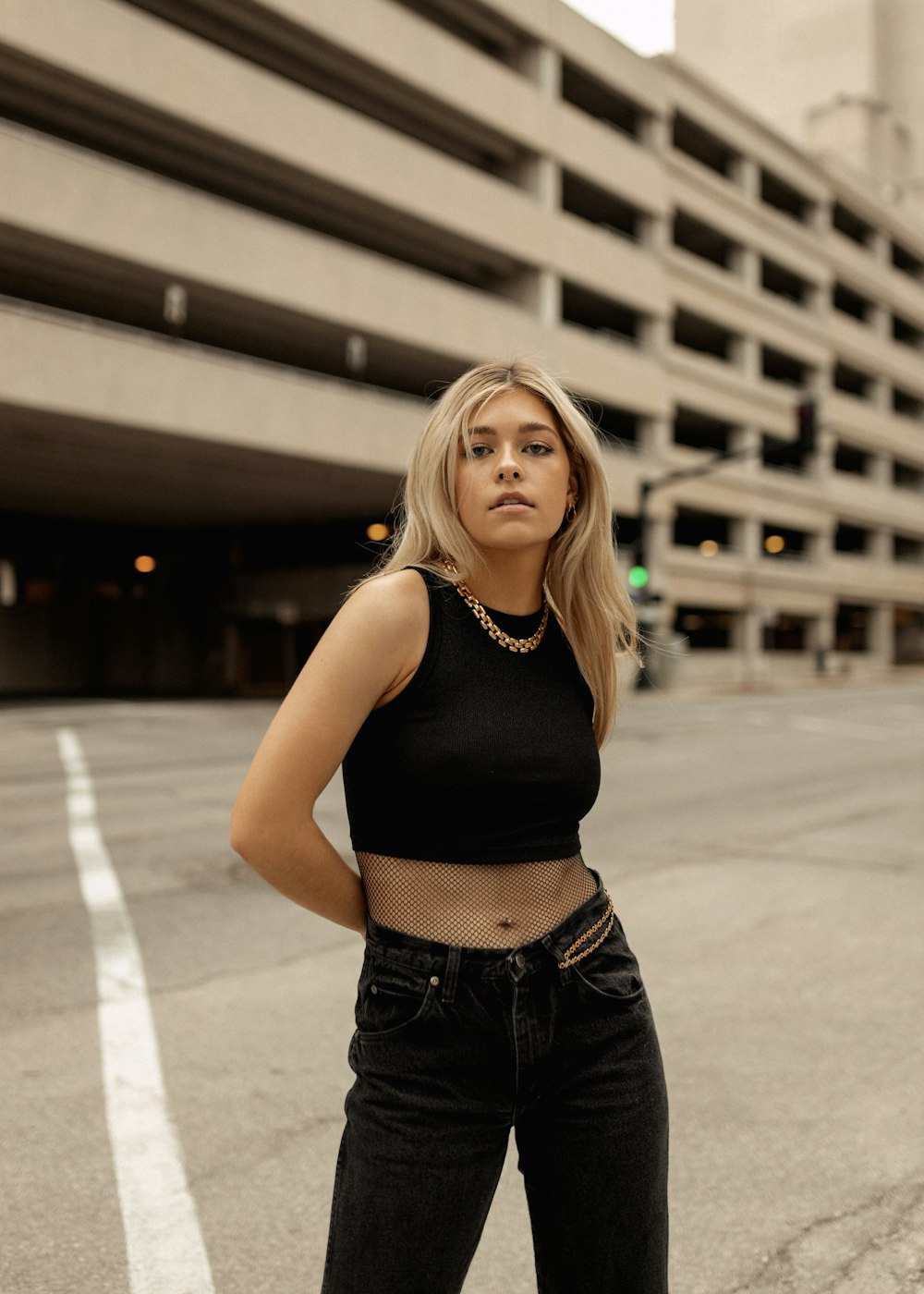 a woman standing in the middle of a parking lot