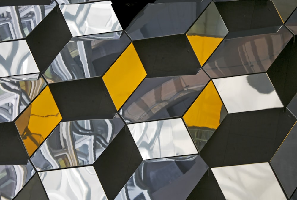 a close up of a mirrored surface with a clock in the background