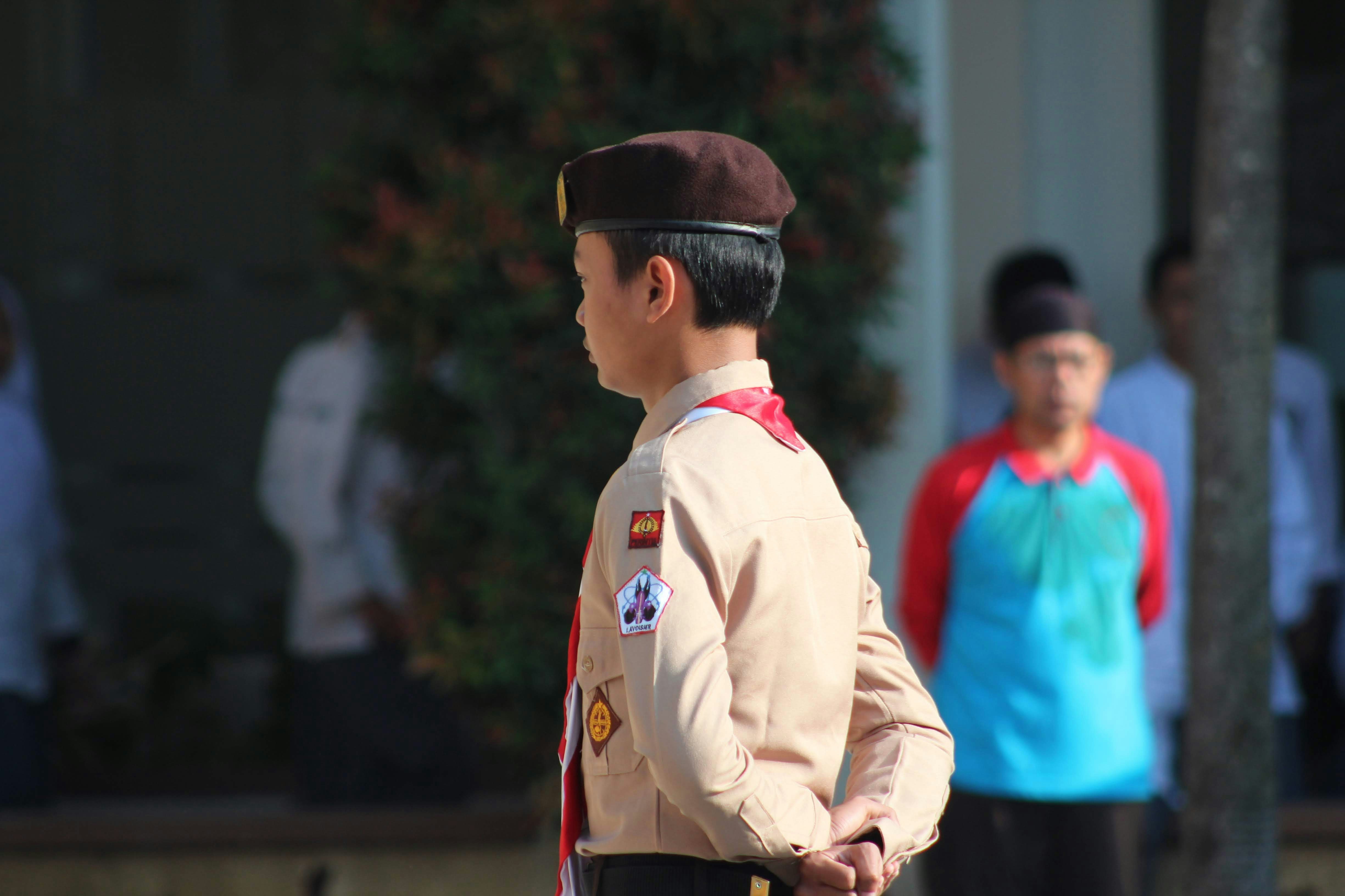 a man in uniform standing in front of a building