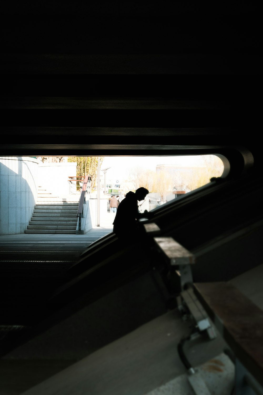 a man riding an escalator down a set of stairs