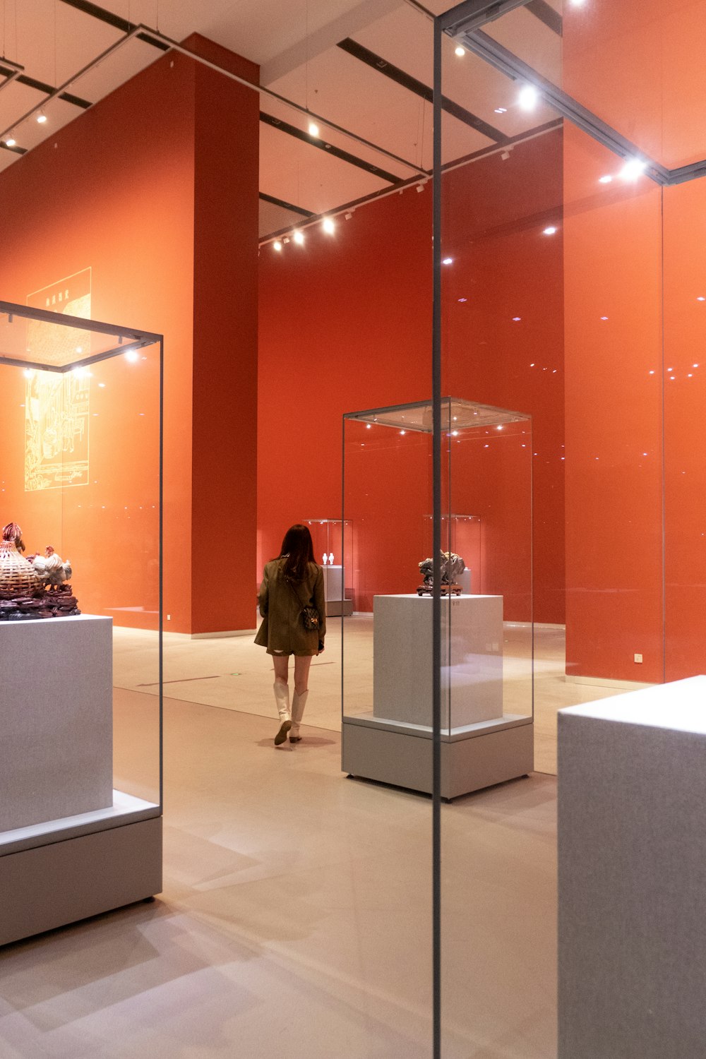 a woman is walking through a museum exhibit