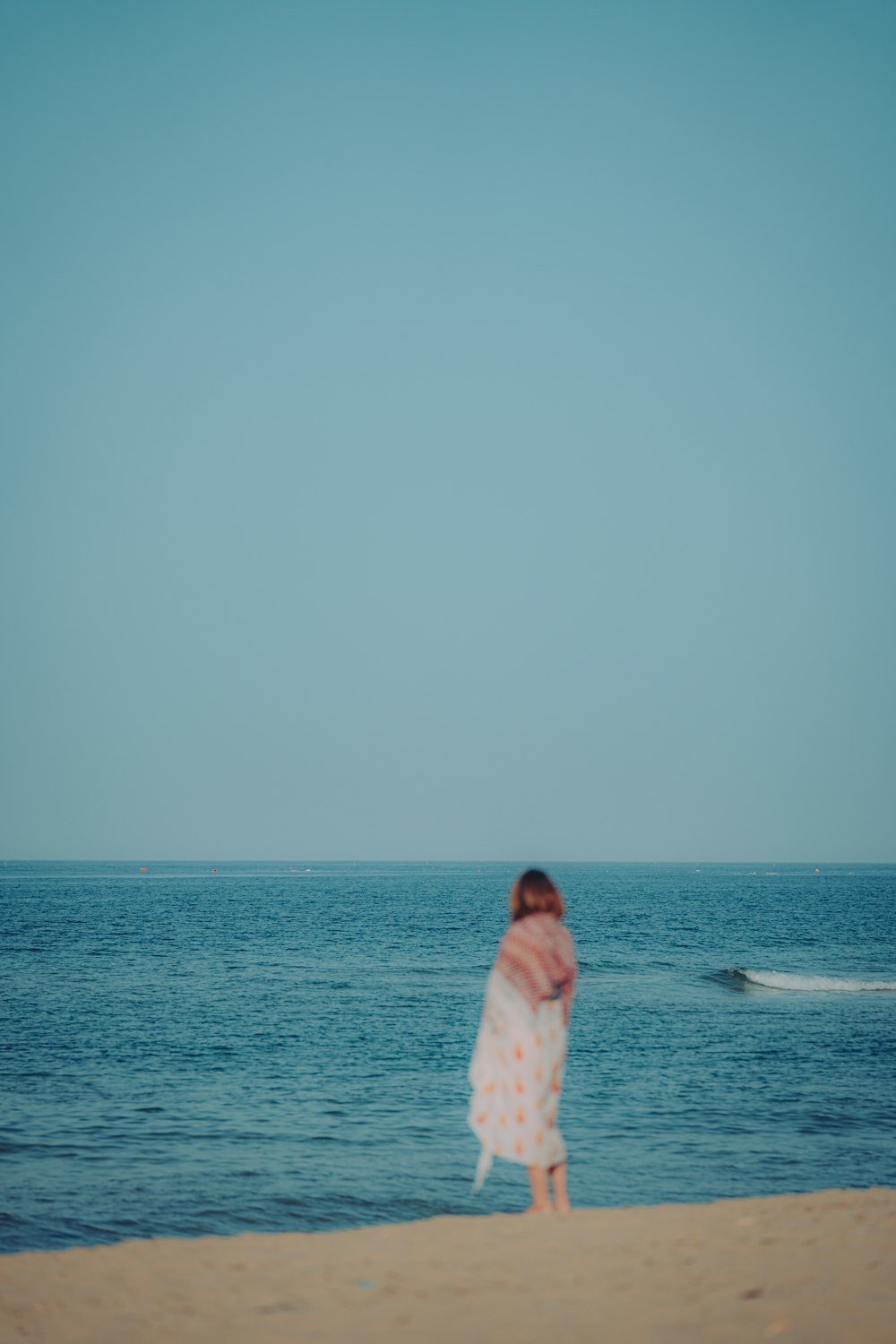a woman in a white dress on a beach