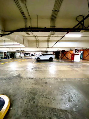 A customer happily retrieving their car from a covered parking area with clear signage.