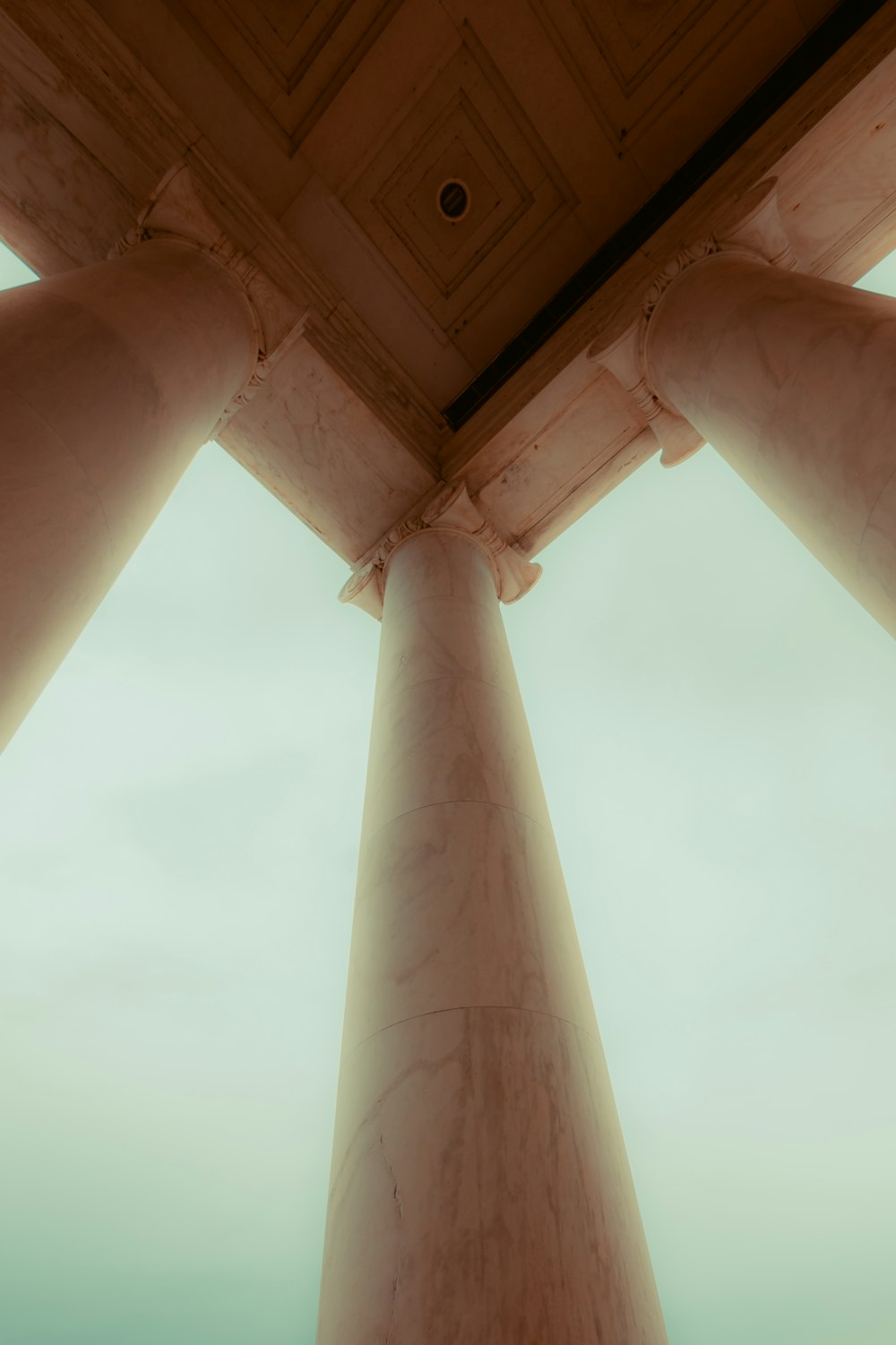 a group of pillars with a sky in the background