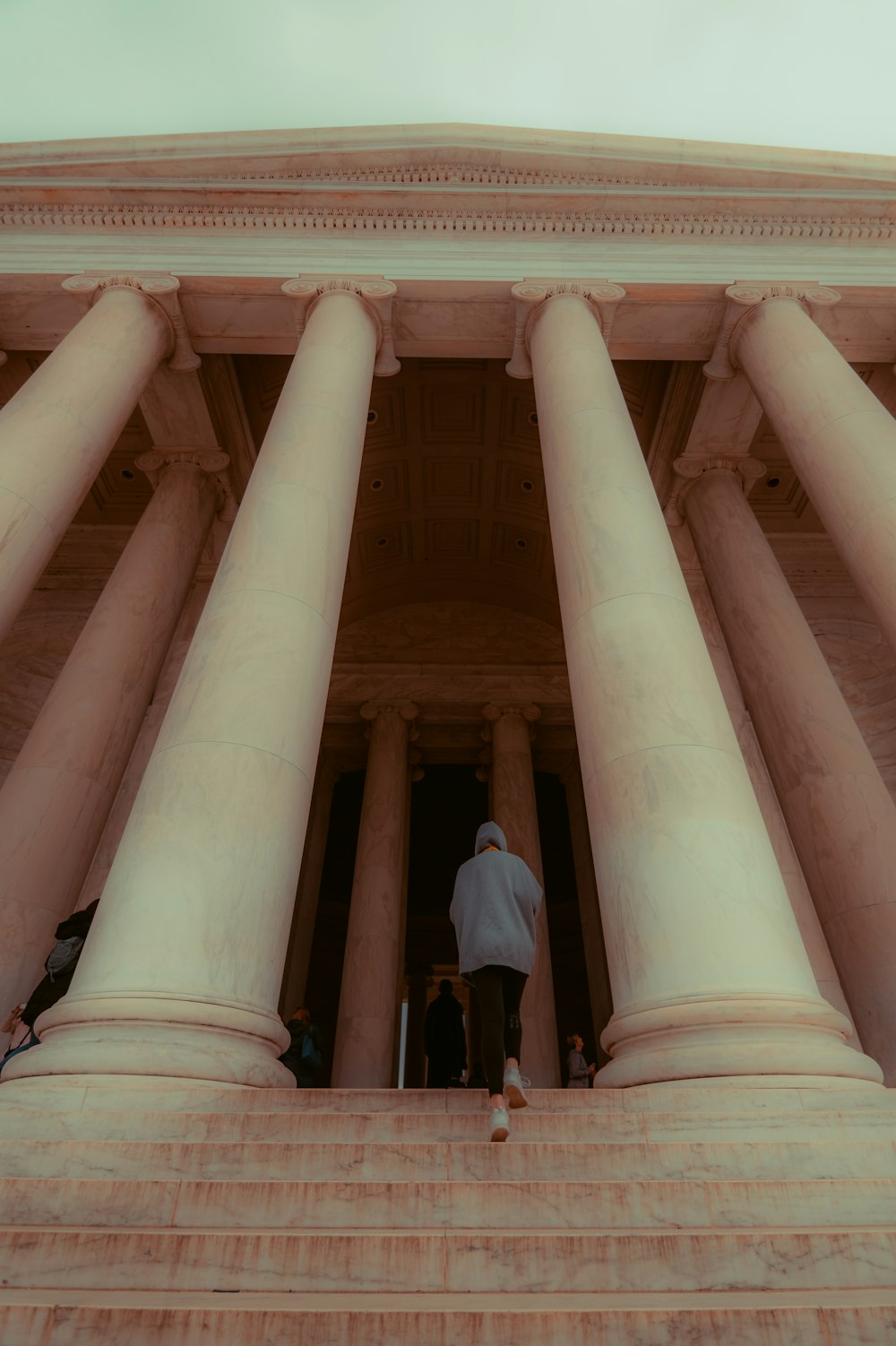 a man standing on the steps of a large building