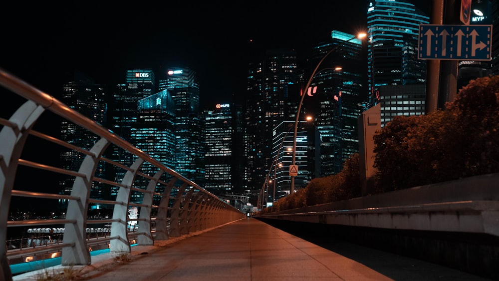 a view of a city at night from a bridge