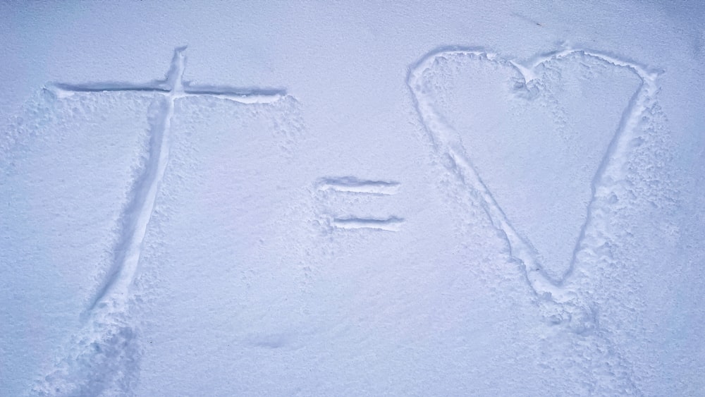 a cross and a word written in the snow