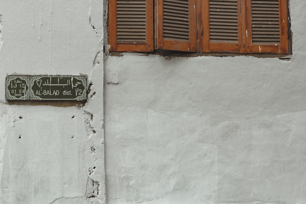 a sign on the side of a white building