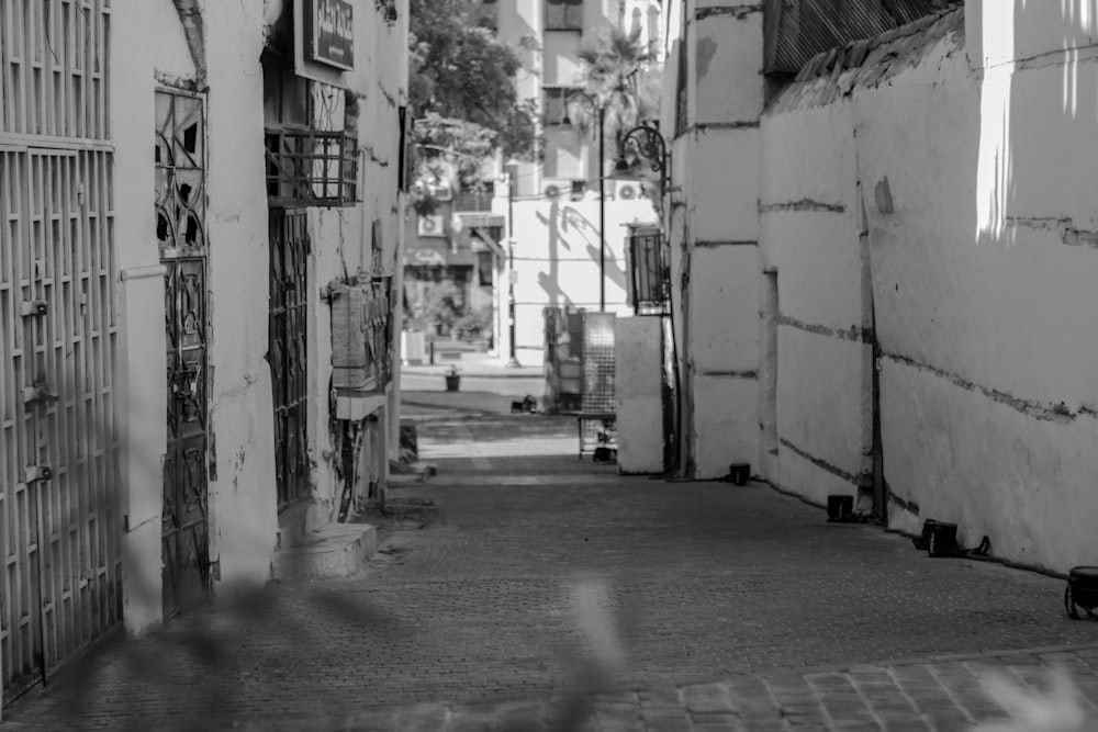 a black and white photo of a narrow street