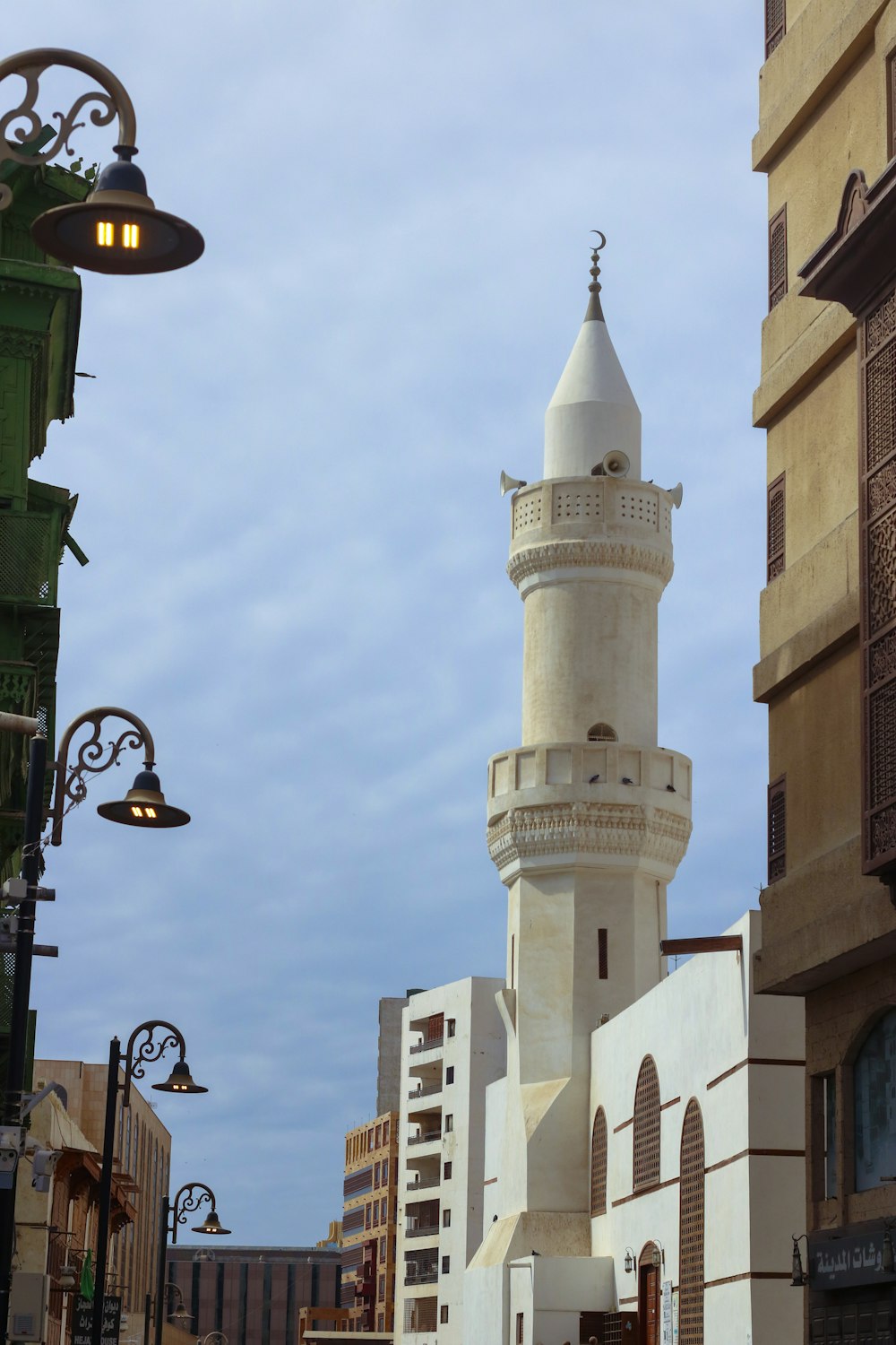 a tall white tower sitting next to a tall building