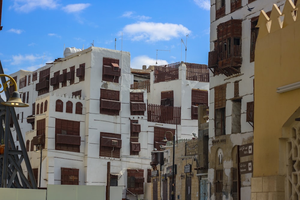 a city street lined with tall white buildings