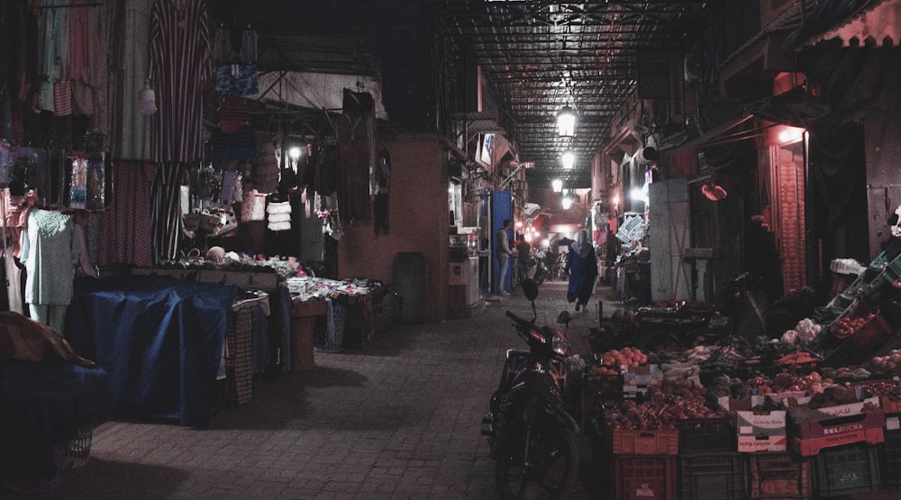 a narrow alley with a lot of items on display