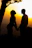 A romantic silhouette of a couple holding hands at sunset.