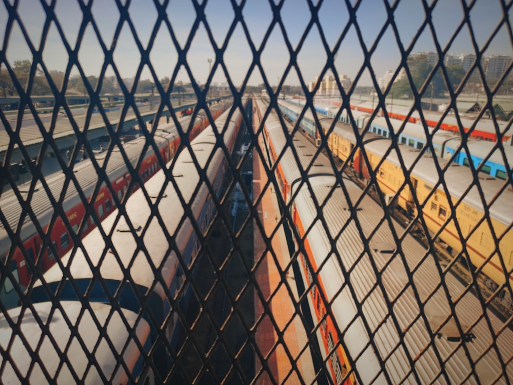 a view of a train yard through a chain link fence