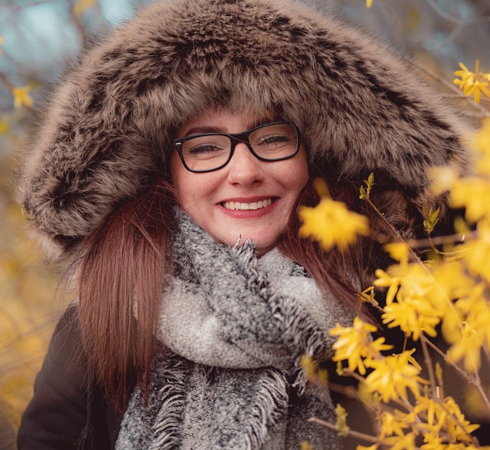 a woman wearing a fur hat and scarf