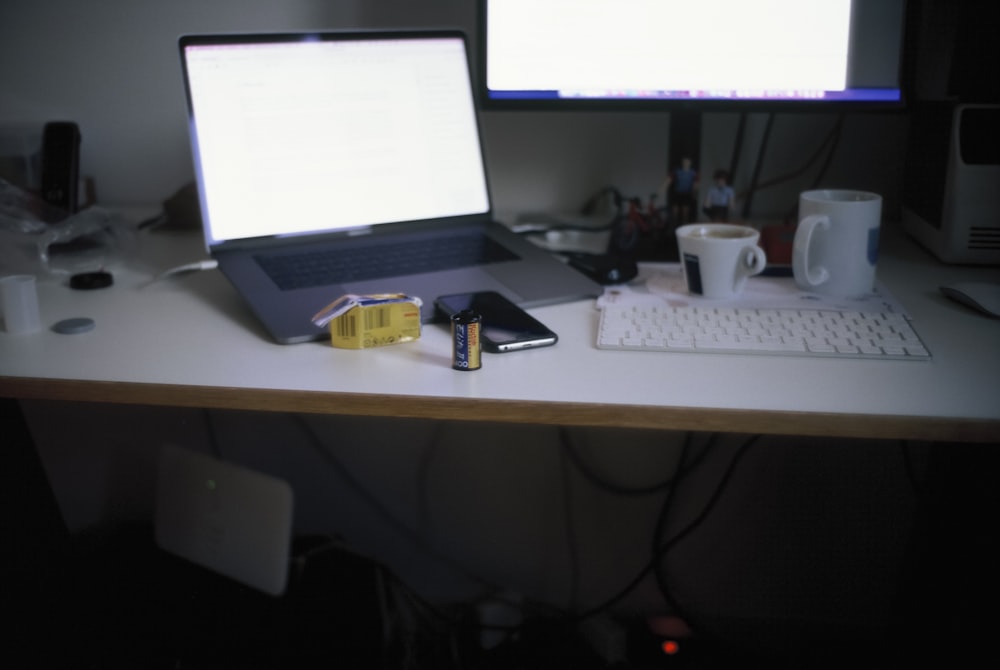 a laptop computer sitting on top of a desk