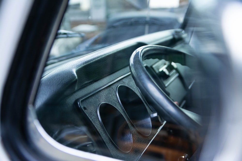 a close up of a car's steering wheel and dashboard