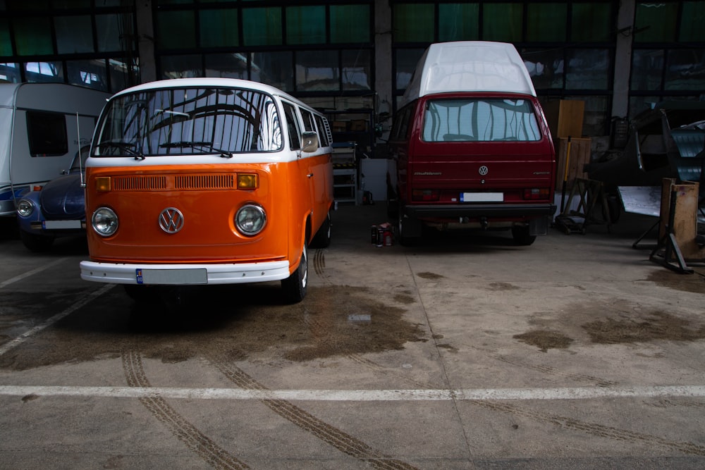 an orange and white vw bus parked in a garage