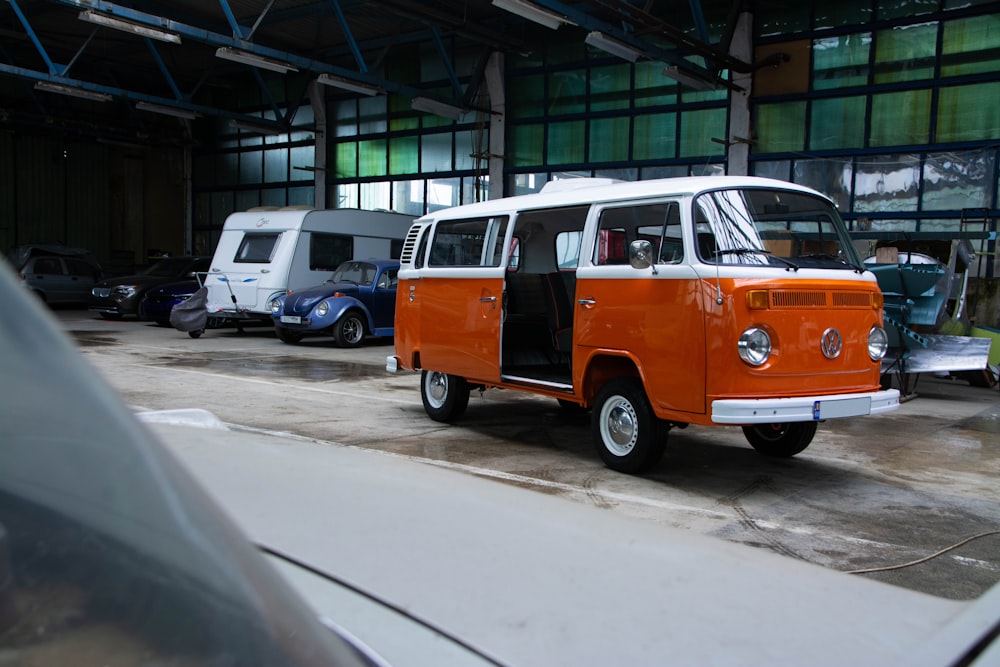 an orange and white van parked in a garage
