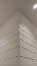 Close-up of drywall being installed in a modern interior.