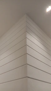 Close-up of a smooth drywall finish in a bright kitchen renovation, highlighting the clean, professional work by the team.