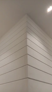 Modern interior wall with smooth plasterboard finish and integrated lighting.