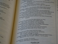 A close-up of an open book with printed text, focusing on several paragraphs organized by numbers and verses. The page appears to be from a religious or spiritual book.