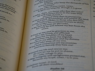 A close-up of an open book with printed text, focusing on several paragraphs organized by numbers and verses. The page appears to be from a religious or spiritual book.