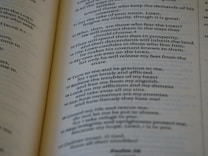 A close-up of an open book with printed text, focusing on several paragraphs organized by numbers and verses. The page appears to be from a religious or spiritual book.