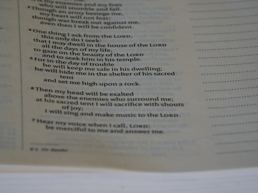 A close-up view of a page from a book, focusing on a passage that appears to be religious or spiritual text. The text is formatted in a structured, verse-like manner, with some lines in italics and numbers indicating sections or verses.