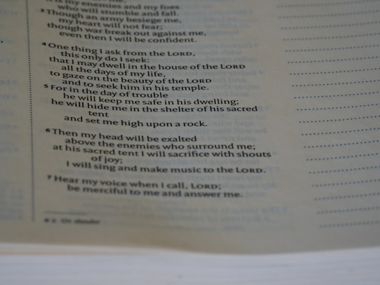 A close-up view of a page from a book, focusing on a passage that appears to be religious or spiritual text. The text is formatted in a structured, verse-like manner, with some lines in italics and numbers indicating sections or verses.