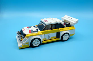 Close-up of a completed Lego race car with shiny wheels, ready to zoom across the floor.