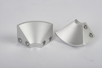 a pair of metal parts on a white background